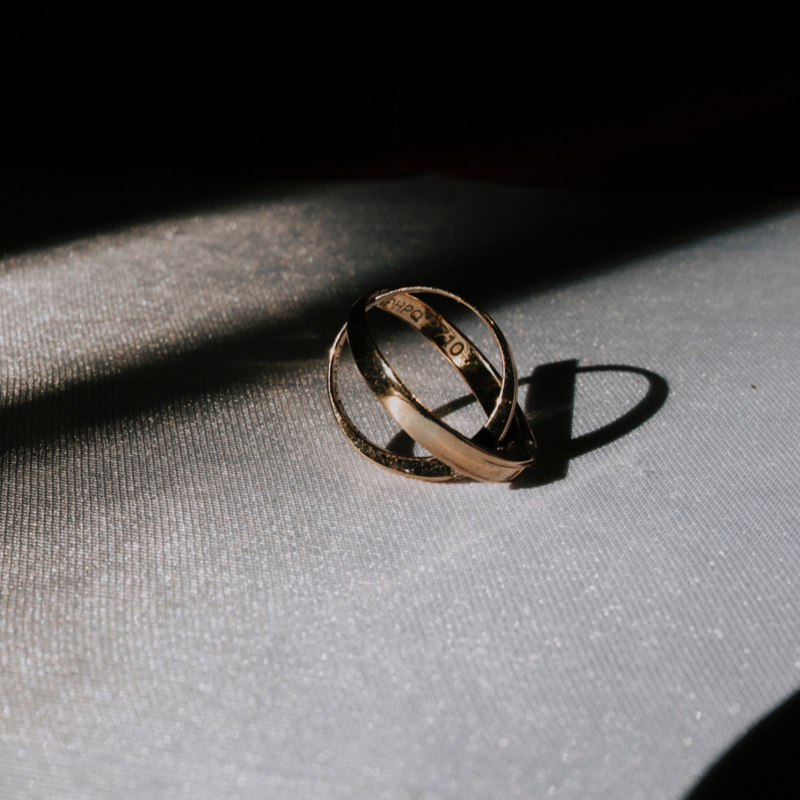 two rings sitting on a table bathing in the sunshine from a window